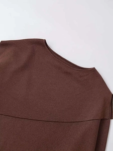 Close-up of dark brown knit top featuring an asymmetrical fold-over collar and fine texture