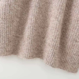 Oatmeal knit sweater detail showing fuzzy texture and ribbed hem for cozy winter wear