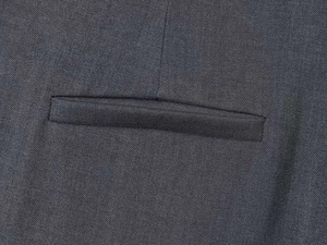 Close-up of deep grey twill fabric texture and well-crafted welt pocket detail on trousers