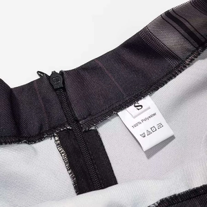 Detail view of plaid skirt waist with black invisible zipper and S size wash label