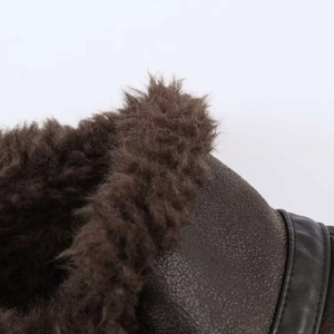 Macro shot of dark brown pebbled leather jacket with thick faux fur lining detail