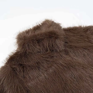Short faux fur coat in dark brown showing thick high-quality plush texture detail