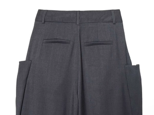 Detail of high-waist charcoal grey trousers featuring back welt pockets and side cargo pockets