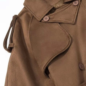 Detail of dark brown faux suede trench coat featuring wide lapels and resin buttons