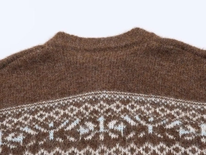 Close-up of brown mohair sweater neckline with blue and white snowflake jacquard