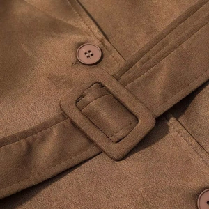 Macro shot of brown faux suede fabric featuring a matching waist buckle and button detail
