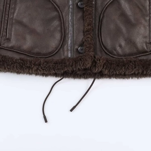 Detail of vintage brown leather flight jacket with plush trim and large utility pockets