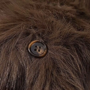 Close-up of marble-patterned resin button on brown faux fur coat showing texture