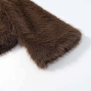 Macro detail of plush brown faux fur fabric showing dense and soft long hair texture