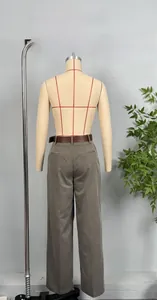 Detail of high-waist wide-leg trousers in taupe with a brown leather belt and back pocket