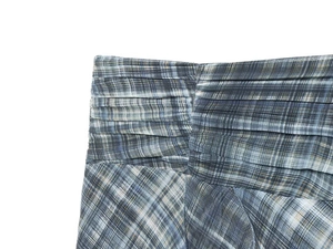 Detail of blue-grey plaid skirt featuring intricate smocking at the elastic waistline