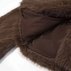Detail view showing thick brown faux fur texture and matching silky inner lining of the coat