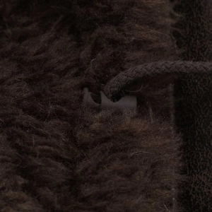 Detail of dark brown faux fur jacket showing the texture and adjustable drawstring lock