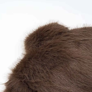 Detailed close-up of dark brown faux fur texture showing soft and silky synthetic fibers