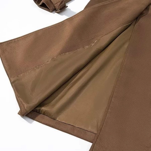 Detail of brown faux suede coat showing smooth inner lining and cuff adjustment straps
