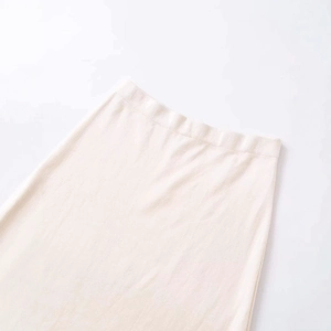 Elegant beige knit midi skirt featuring a fine ribbed texture and elastic high waist