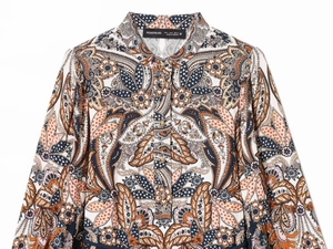 Detail view of vintage paisley print shirt with gold buttons and mandarin collar