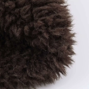 Close-up of high-density dark brown faux fur texture on a reversible flight jacket