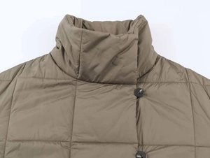 Detail of high stand collar and olive green quilted puffer jacket with dark buttons