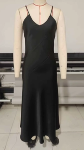 Close-up of elegant black satin maxi slip dress with deep V-neck and silky texture