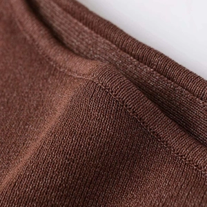Close-up of dark brown knit sweater showing high-quality texture and stitching details