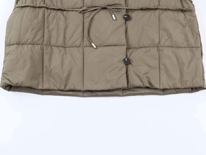 Detail of square quilted puffer jacket with adjustable drawstring waist and metal aglets