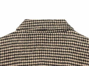 Detail of houndstooth jacket collar and shoulder stitching on premium tweed fabric