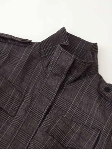 Detail of windowpane check jacket with stand-up collar, epaulettes and flap pockets