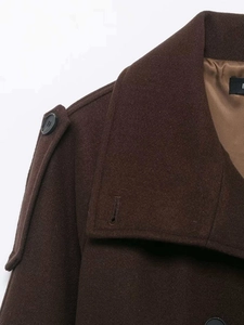 Detail of wool blend coat showing refined lapel collar and premium fabric texture