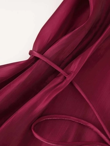Detail view of the wine red satin shirt fabric showing smooth texture and belt loop