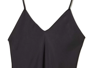 Detail of a black satin dress with delicate spaghetti straps and elegant V-neckline