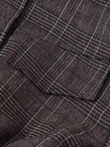 Macro shot of brown plaid fabric texture with detailed blue and white weave lines