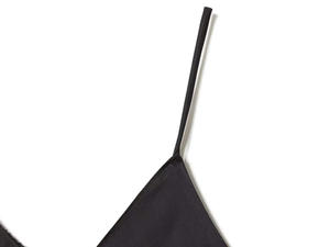 Close-up of sleek black satin dress showing fine stitching on delicate spaghetti straps