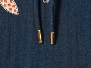 Detail of navy printed shirt dress with gold-tipped drawstrings and fabric texture