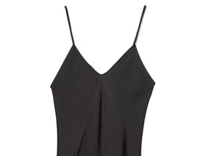 Detail of elegant black satin slip dress showing thin straps and classic V-neckline