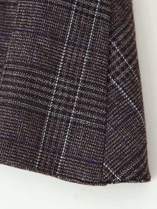 Detailed macro view of dark coffee plaid fabric texture with blue and white stripes