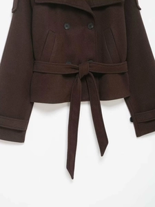 Detailed macro shot of dark brown wool blend jacket showing lapel and double-breasted buttons