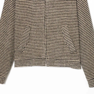 Classic houndstooth bomber jacket with metal zipper and ribbed hem on white background