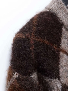Close-up of diamond pattern mohair cardigan with thick and soft knit fabric texture