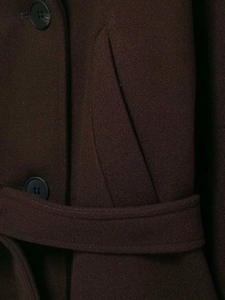 Detail of wool-like short coat featuring large round buttons, side pockets and a matching belt