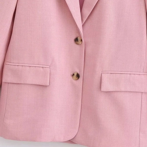 Classic light pink blazer for women featuring notch lapels and tortoiseshell buttons