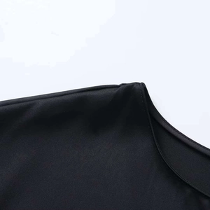 Close-up of the smooth black round neckline and shoulder stitching on a lace dress