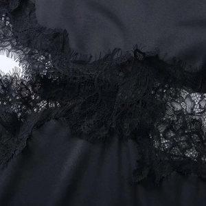 Detail of elegant black lace dress featuring delicate floral embroidery and eyelash trim