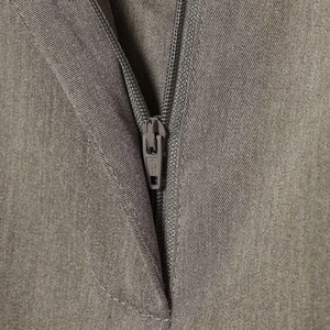 Detail of high-waist wide-leg trousers featuring a smooth SBS zipper and grey twill fabric
