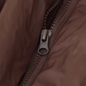Women's winter quilted puffer jacket featuring a durable brown zipper and metal slider