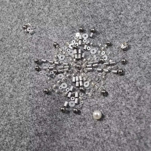 Detail von DIY-Schmuckset mit Silberanhängern, grauen Perlen und weißen Kunstperlen