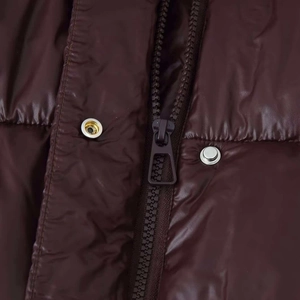 Glänzende dunkelbraune Pufferjacke mit Reißverschluss und Metalldruckknöpfen-Detail