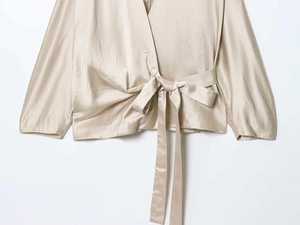 Detail of champagne satin wrap shirt featuring a V-neck and delicate waist bow tie