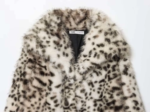 Close-up of the leopard print faux fur coat featuring wide lapels and a smooth inner lining