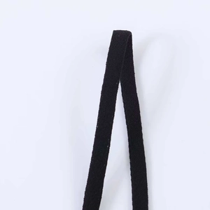 Detailed macro shot of high-quality black elastic lace ribbon with fine twill texture